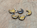 Tiger Eye moon pendant featuring a crescent moon design from GemstoneGO, showcasing the polished gemstone with a silver bail.
