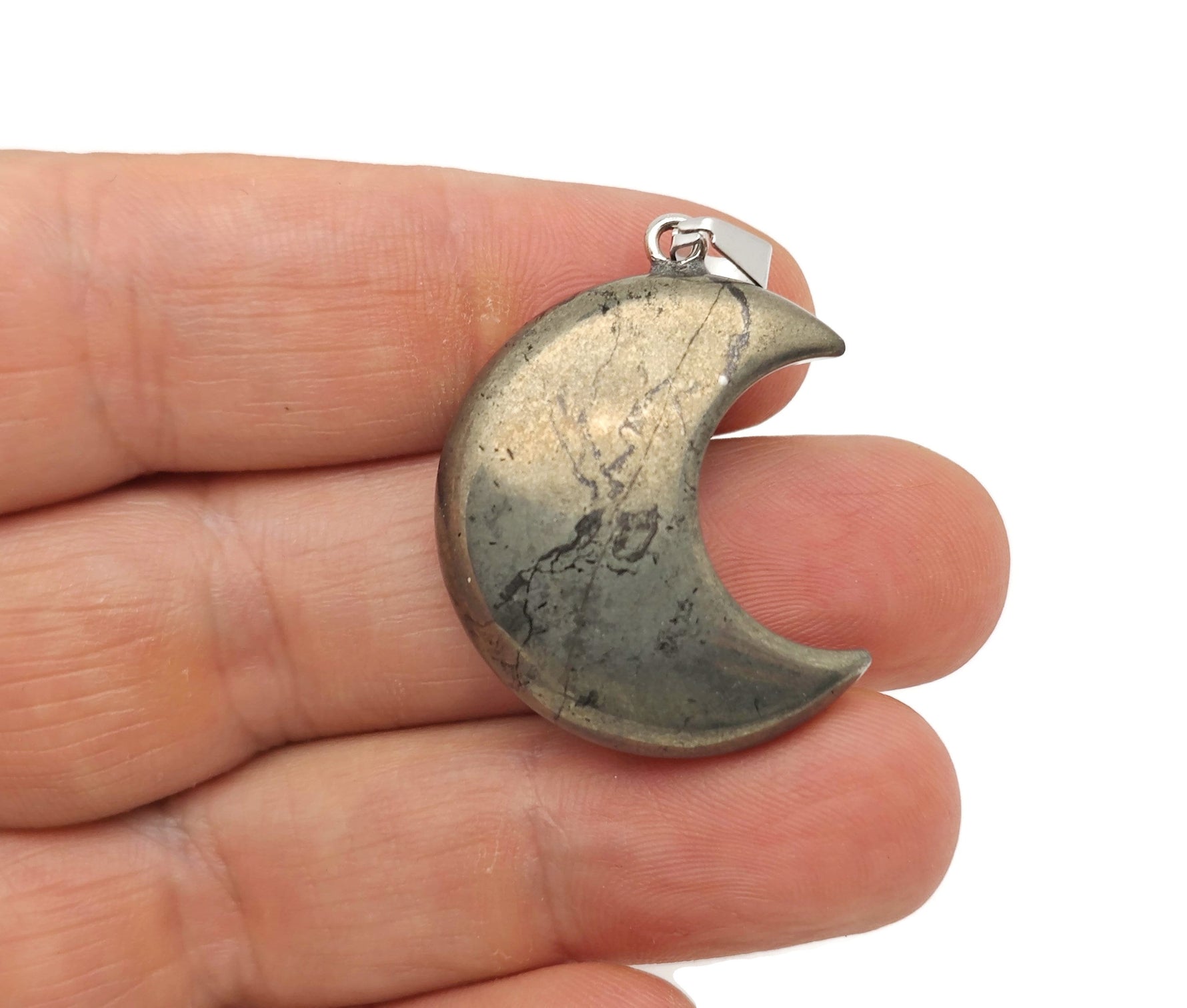 Pyrite moon gemstone pendant featuring a crescent moon design, showcasing the metallic luster and intricate details of the NC1549 pendant.