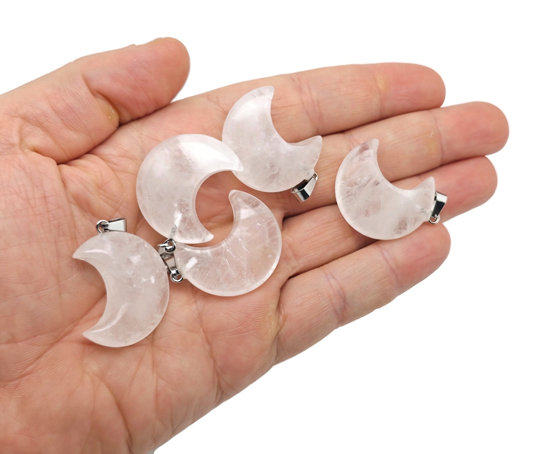 Clear quartz moon gemstone pendant featuring a crescent moon design by GemstoneGO, showcasing a polished, translucent stone on a silver setting.