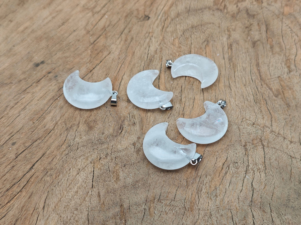 Clear quartz moon gemstone pendant featuring a crescent moon design from GemstoneGO, showcasing a polished, luminous stone on a silver chain.