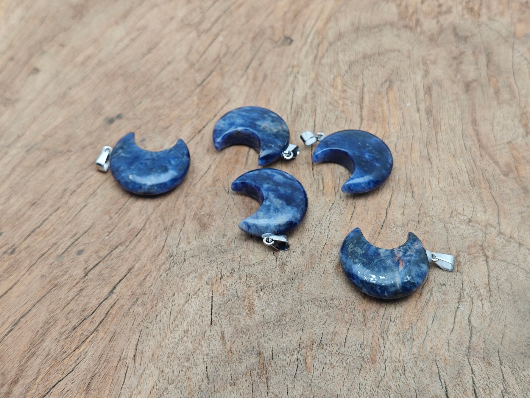 Sodalite moon gemstone pendant featuring a crescent moon design by GemstoneGO, showcasing deep blue and white stone details.