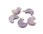 Lepidolite moon gemstone pendant featuring a crescent moon design, showcasing purple hues and polished surface.