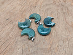 Moss agate moon gemstone pendant featuring a crescent moon design by GemstoneGO, showcasing green and brown natural stone details.
