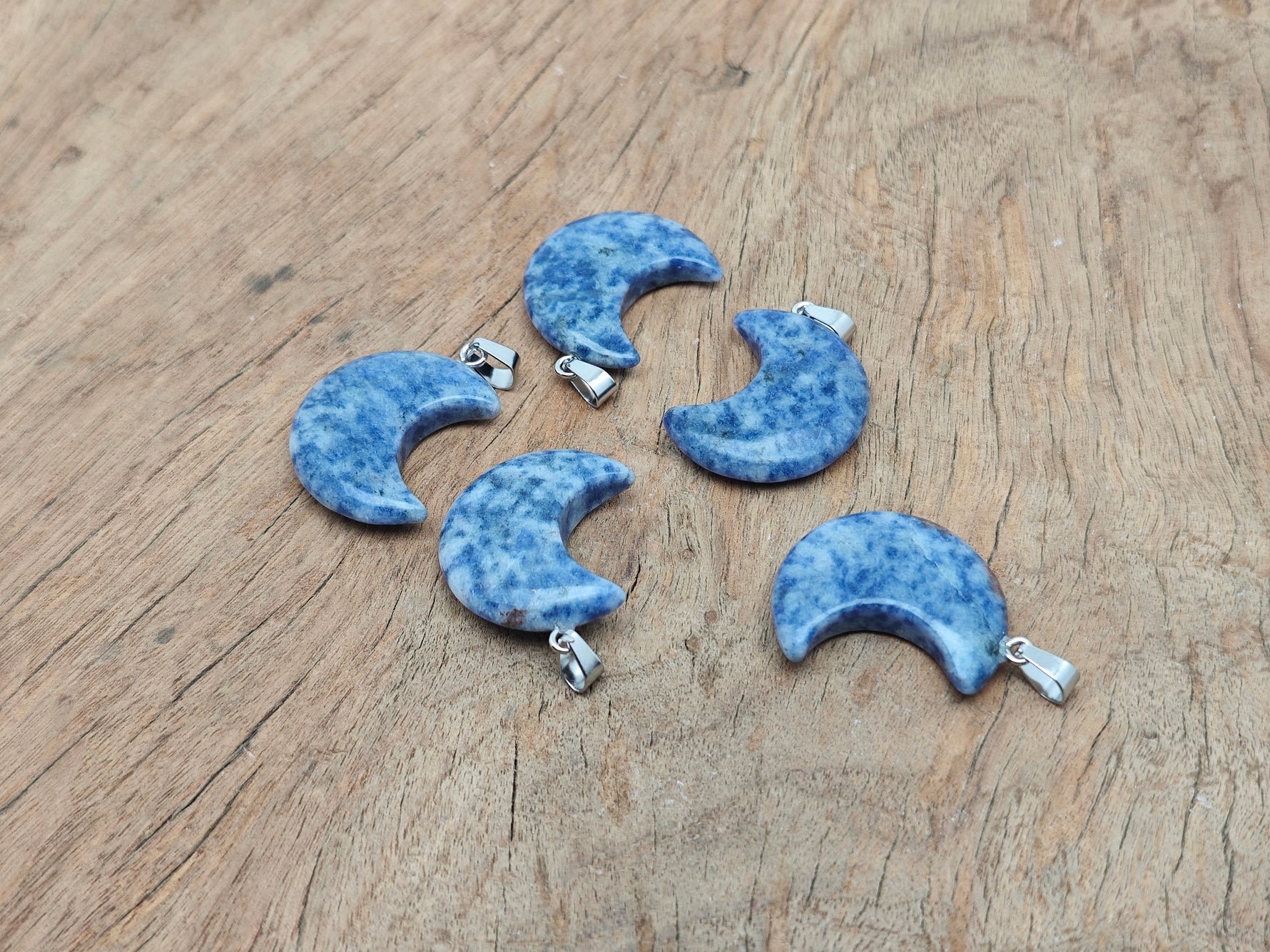 Blue Spot Jasper moon pendant featuring a crescent moon design from GemstoneGO, showcasing a polished gemstone with intricate patterns.