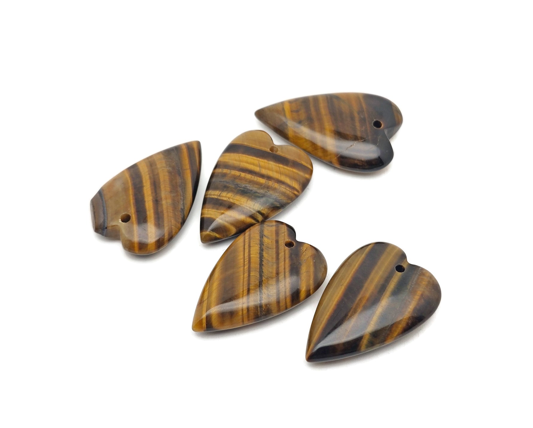 Heart-shaped Tiger Eye crystal pendant featuring a long heart design, showcasing warm golden-brown gemstone with polished finish.