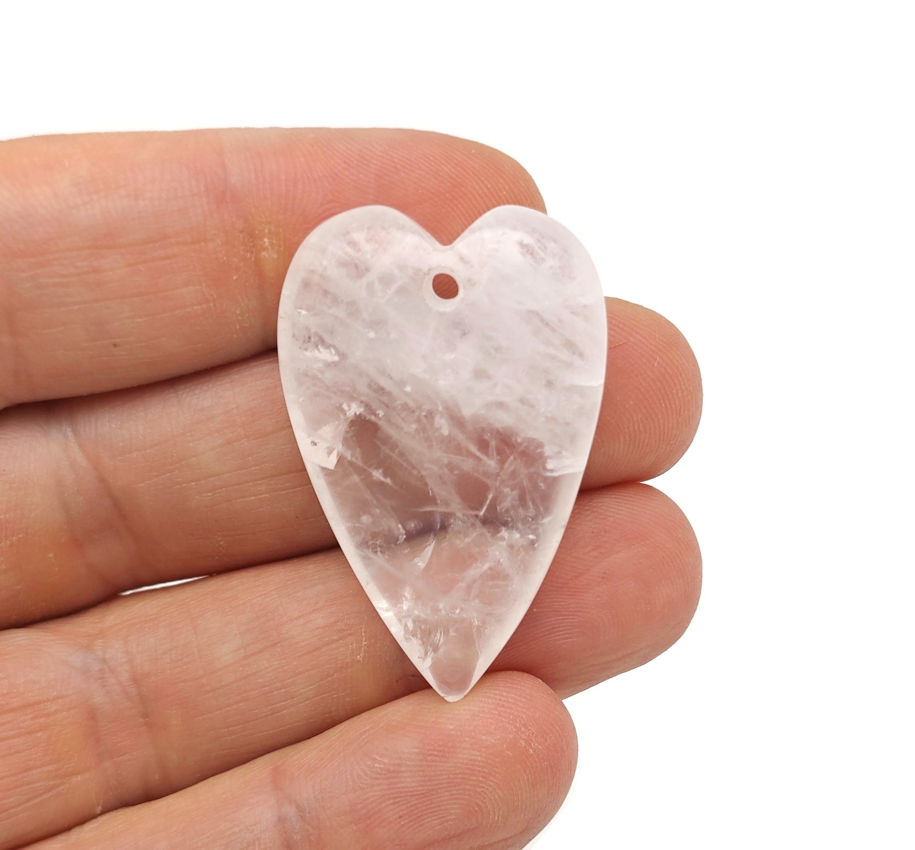 Clear quartz heart-shaped pendant with a polished gemstone, featuring a silver bail for necklace attachment, from GemstoneGO.