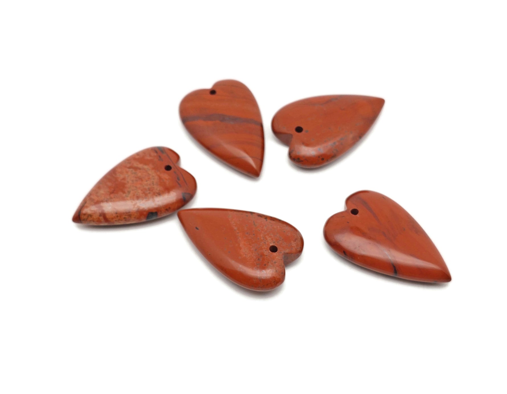 Red Jasper long heart-shaped love crystal pendant from GemstoneGO, featuring a vibrant heart-shaped healing gemstone.