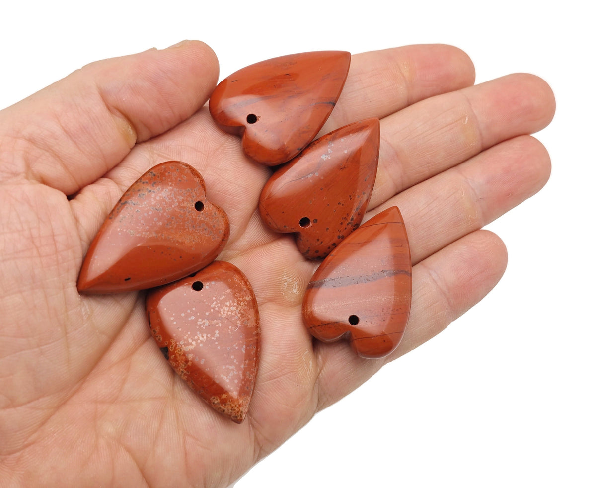 Red Jasper long heart-shaped love crystal pendant featuring a polished heart-shaped healing gemstone on a silver chain.