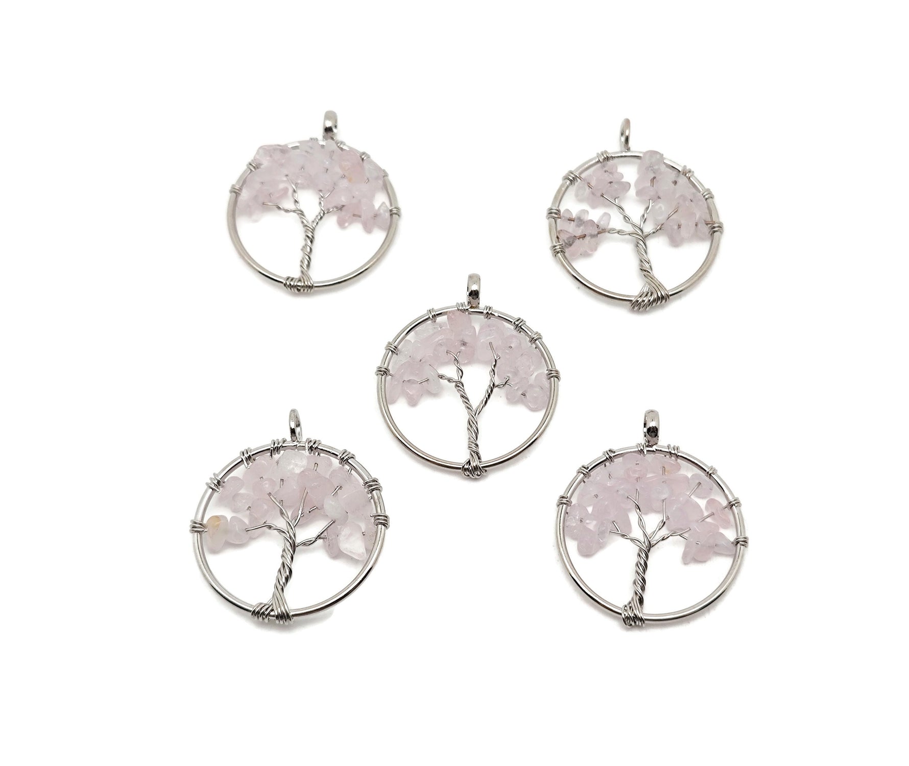 Rose quartz Tree of Life gemstone pendant from GemstoneGO, showing the intricate crystal gemstone design on a silver-toned pendant.