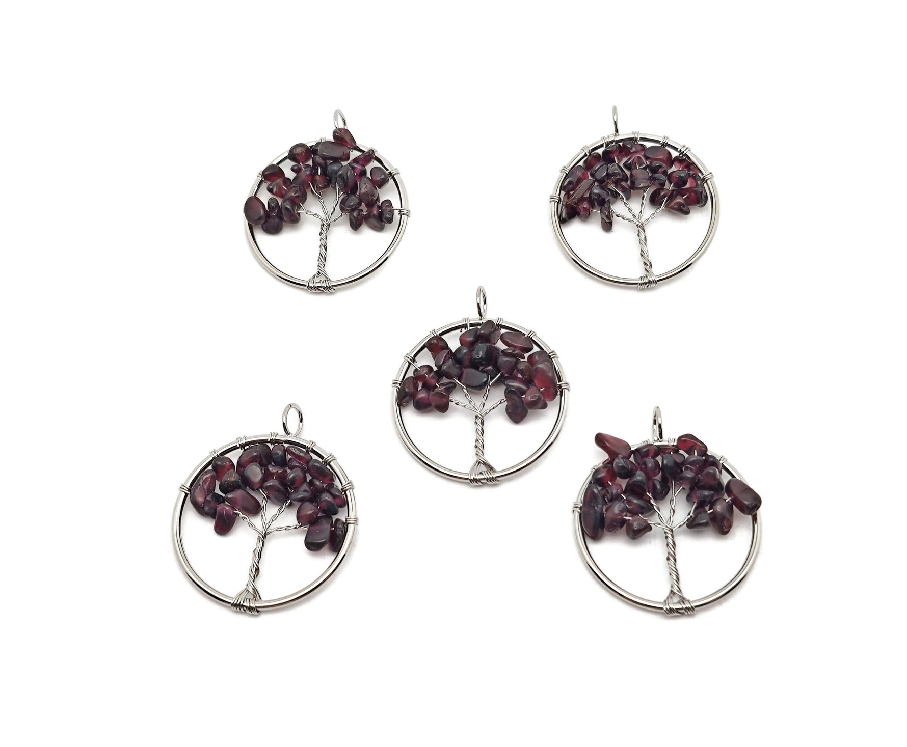 Garnet Tree of Life gemstone pendant from GemstoneGO featuring a detailed gemstone crystal design on a silver setting.