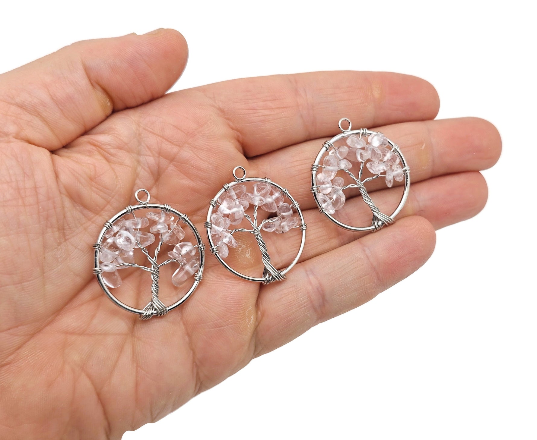 Clear Quartz Tree of Life gemstone pendant with intricate wire wrapping, showcasing a detailed crystal design by GemstoneGO.