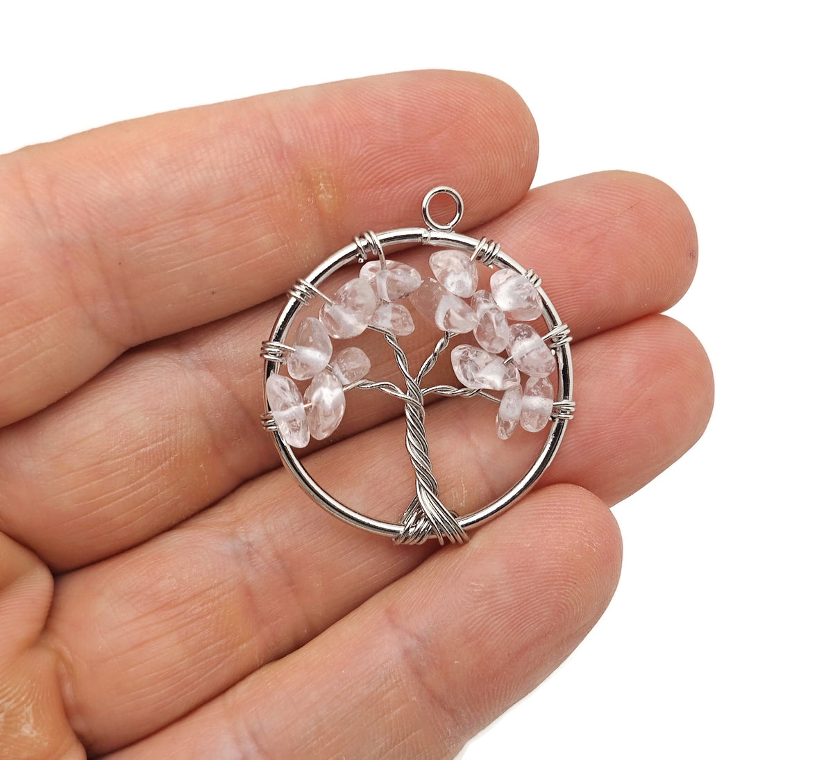 Clear Quartz Tree of Life gemstone pendant by GemstoneGO featuring intricate wire wrapping and a detailed tree design.