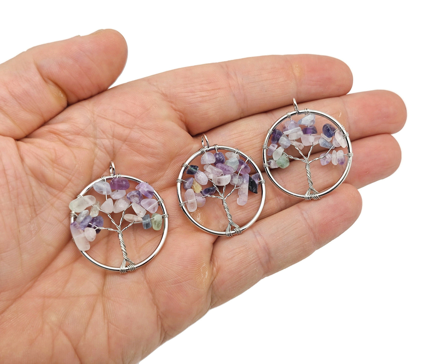Fluorite Tree of Life gemstone pendant from GemstoneGO featuring vibrant green and purple fluorite crystals on a metal branch.