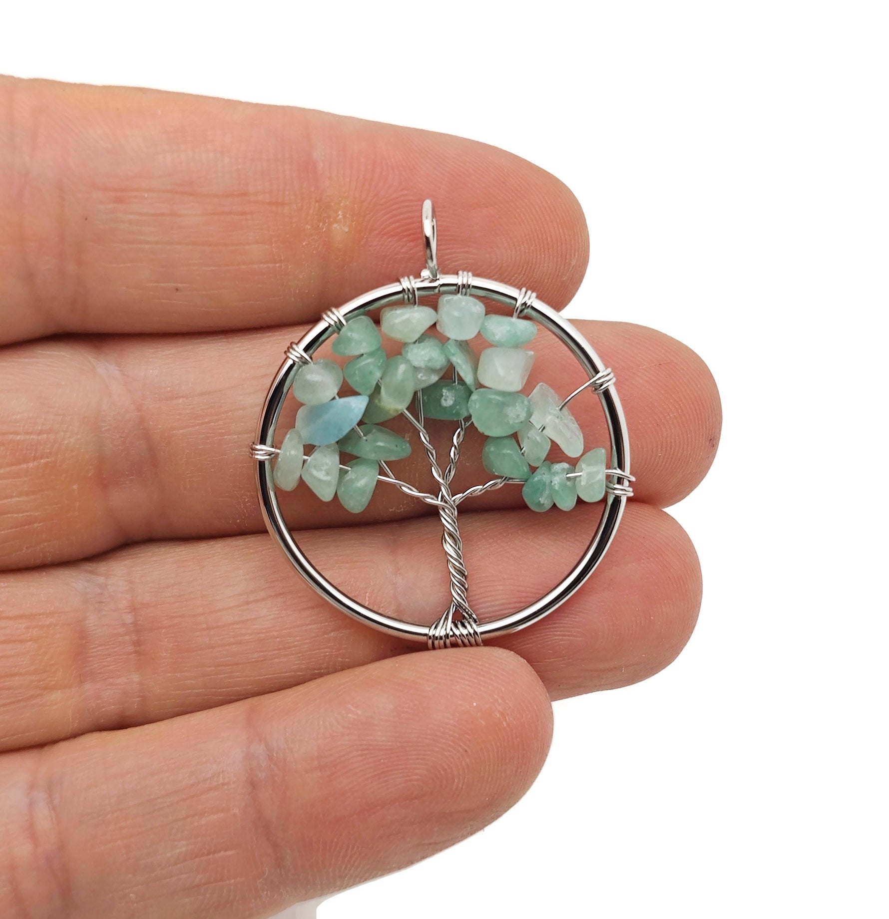 A gemstone Aventurine Tree of Life pendant with intricate wire wrapping, showcasing green and earthy tones for spiritual jewelry.
