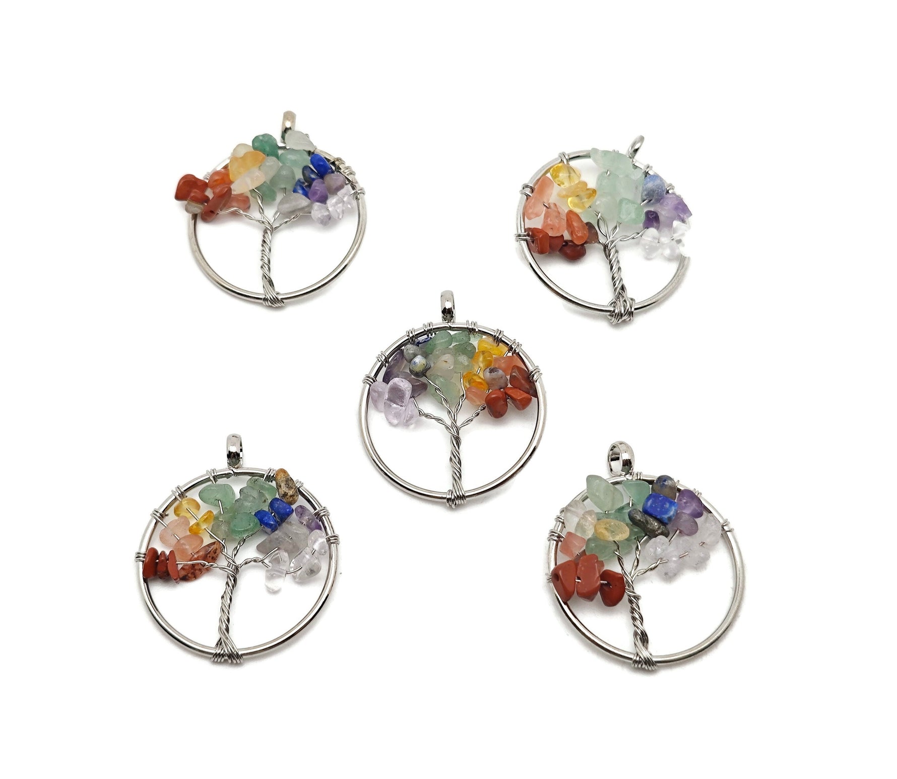 Seven chakra Tree of Life gemstone pendant with colorful crystals, featuring a detailed metal tree design, from GemstoneGO.