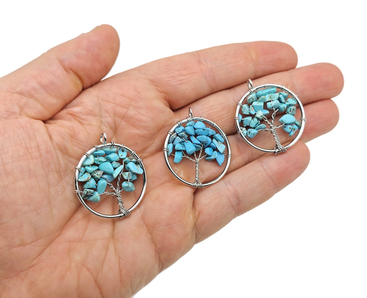 Turquoise Tree of Life gemstone pendant from GemstoneGO featuring a detailed silver setting and vibrant turquoise stones.