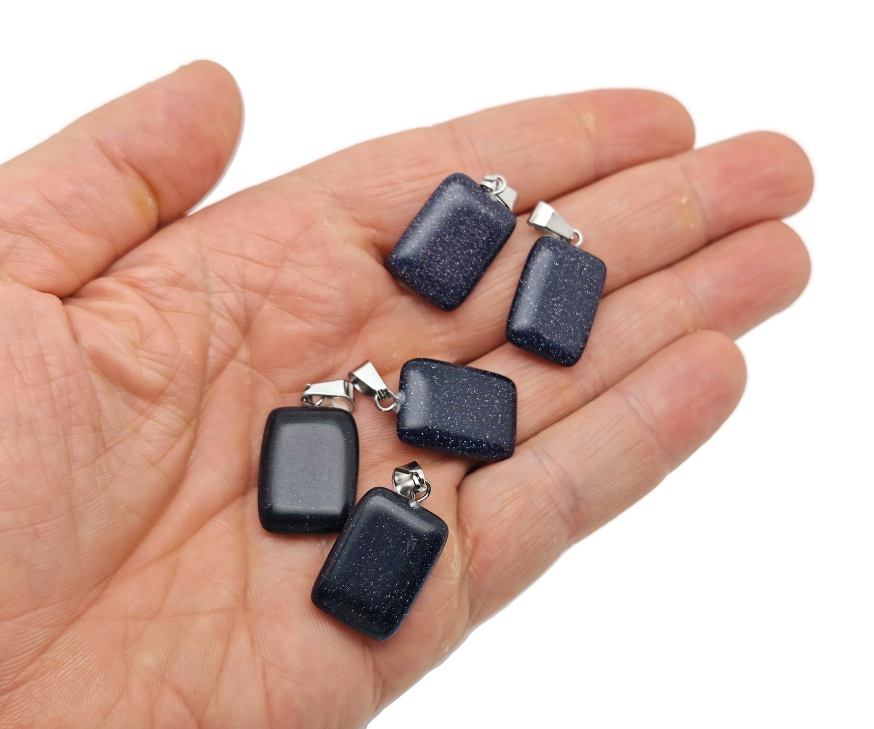 Blue Goldstone rectangle-shaped crystal pendant from GemstoneGO, showcasing a sparkling blue and gold gemstone on a silver setting.