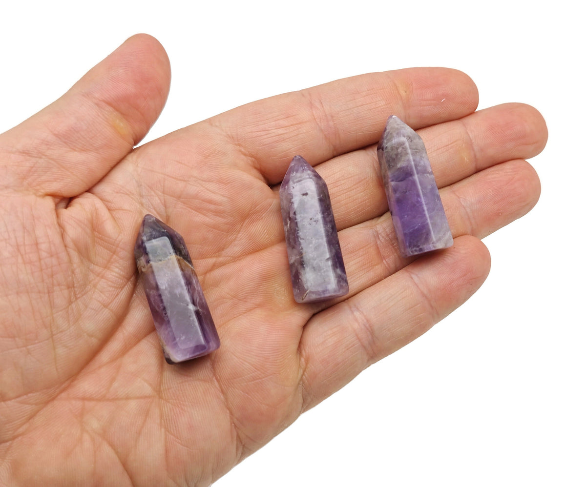 Amethyst obelisk tower crystal, 40mm, from GemstoneGO, showcasing deep purple color and polished geometric shape.