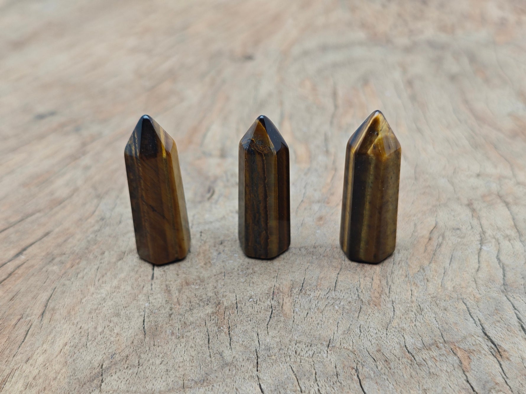 Tiger Eye obelisk tower crystal, 40mm, from GemstoneGO, showing polished brown and golden hues with natural stone patterns.