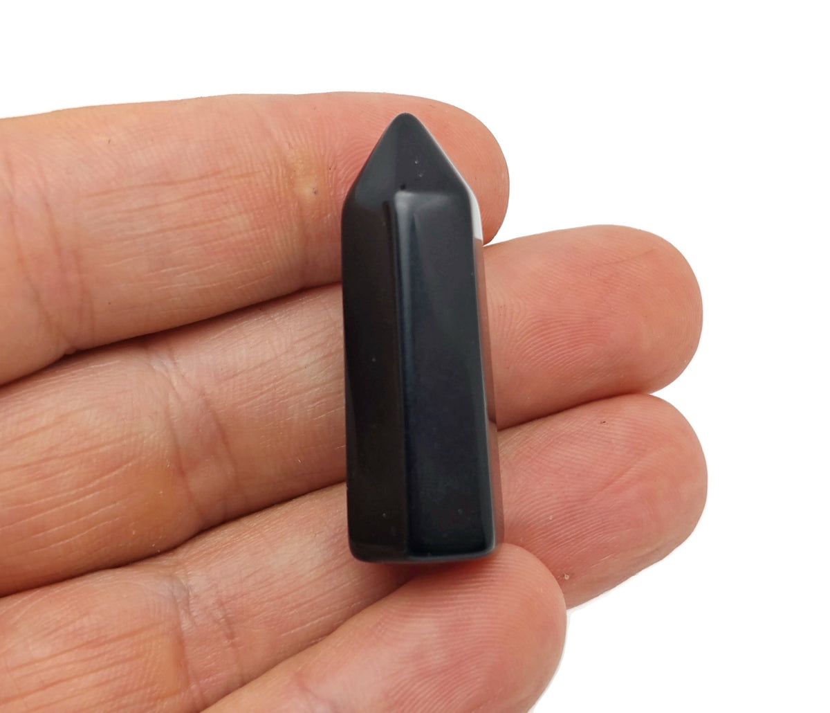 40mm black obsidian obelisk tower crystal from GemstoneGO, featuring a polished, pointed design on a flat base.