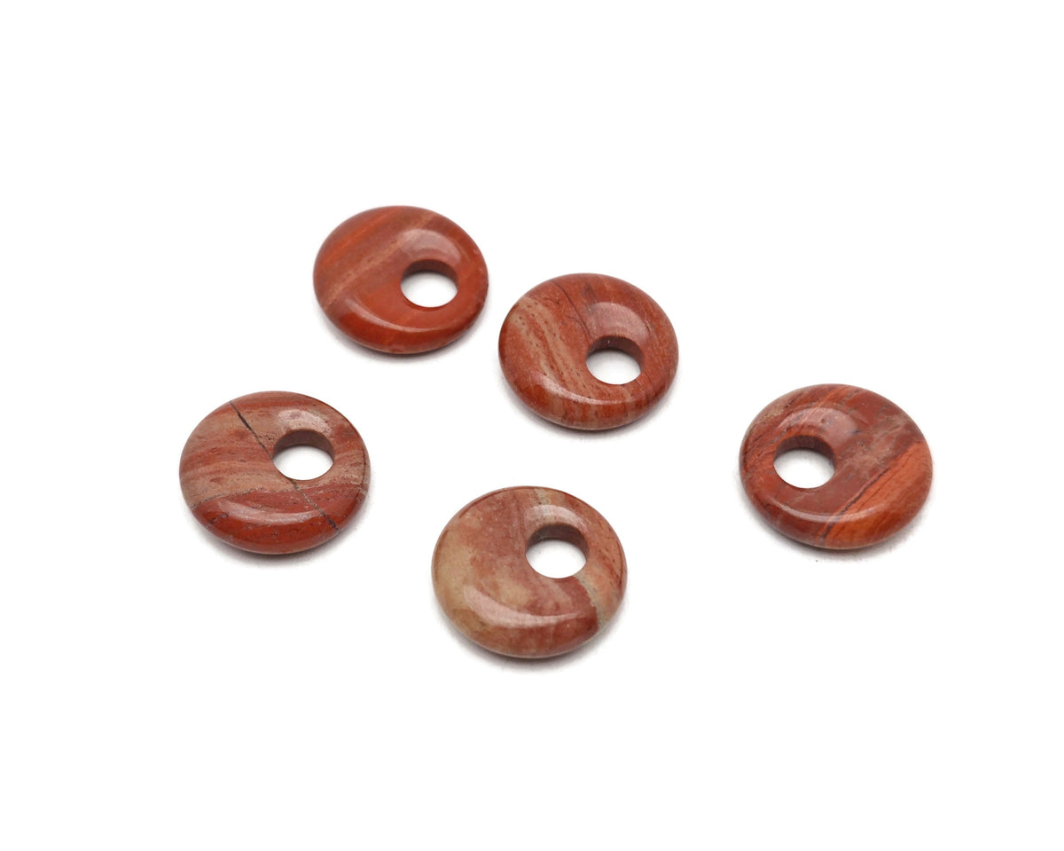 Red Jasper crystal donut pendant from GemstoneGO, 18mm Pi stone with vibrant red hues and smooth, polished surface.