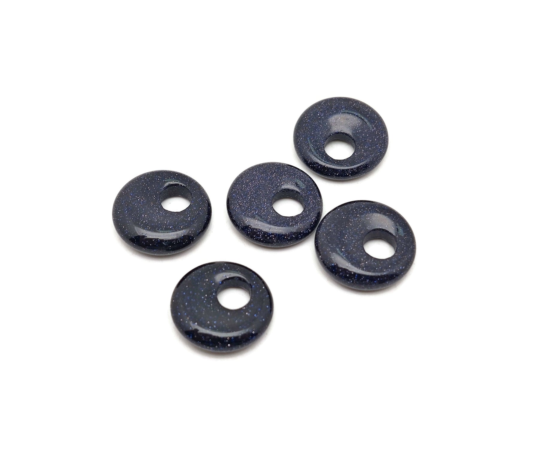 Blue Goldstone crystal donut pendant, 18mm Pi stone from GemstoneGO, showcasing a shimmering blue and gold speckled surface.