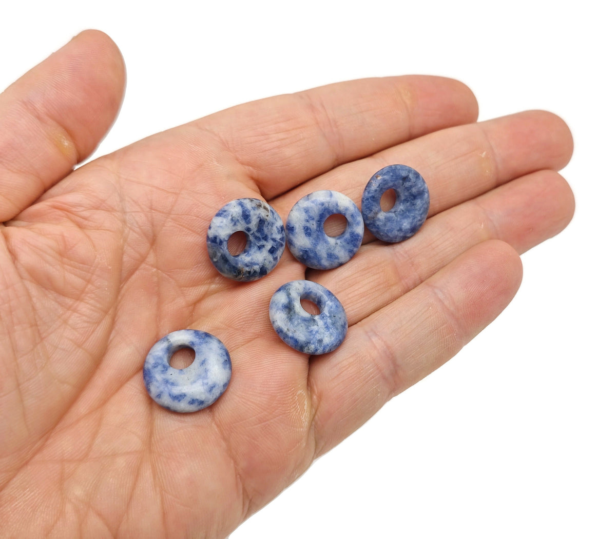 18mm Sodalite crystal donut gemstone with deep blue color and natural patterns, called Pi Stone, from GemstoneGO.