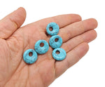 Turquoise crystal donut pendant with Pi stone design, 18mm gemstone from GemstoneGO, showcasing vibrant blue color and polished surface.