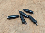Polished obsidian bullet gemstone pendant carved into a bullet shape, featuring smooth, glossy black stone with natural carved details.