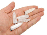 Polished clear quartz bullet gemstone pendant with carved details, featuring a smooth, transparent crystal from GemstoneGO.