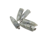 Polished Labradorite bullet gemstone pendant with carved details, showcasing iridescent blue and green hues on a smooth, polished surface.