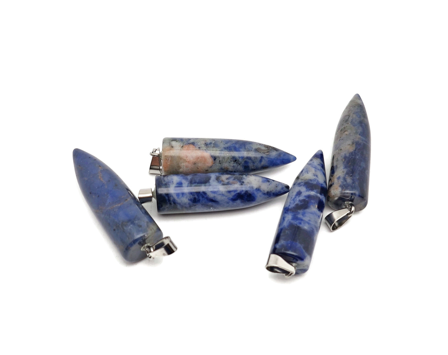 Polished sodalite bullet gemstone pendant with carved details, showcasing deep blue and white natural stone patterns.