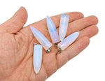 Polished opalite bullet gemstone pendant with carved details, featuring a smooth, translucent gemstone from GemstoneGO.