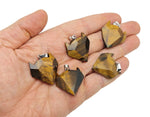 Tiger Eye wolf head gemstone pendant from GemstoneGO, showcasing a detailed crystal jewelry piece with warm golden-brown hues.