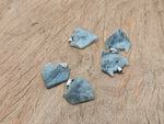 Labradorite wolf head gemstone pendant with intricate crystal jewelry design, showcasing vivid labradorite colors and craftsmanship.