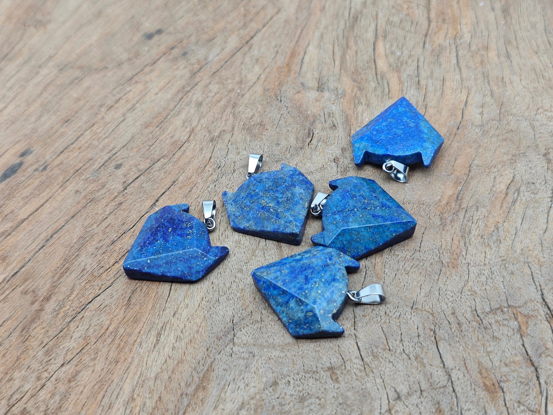 Lapis Lazuli wolf head gemstone pendant from GemstoneGO featuring intricate carved crystal jewelry design.