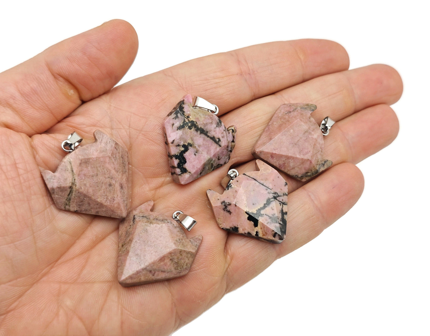 Rhodonite wolf head gemstone pendant from GemstoneGO, featuring a polished crystal jewelry piece with detailed wolf design.