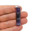 Amethyst bamboo-shaped crystal pendant with protective energy, featuring a polished purple amethyst gemstone on a silver chain.