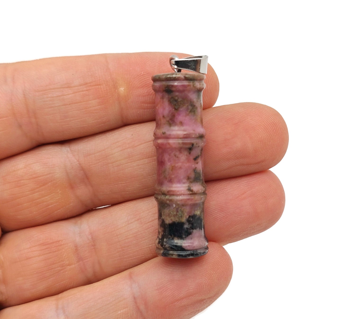 Rhodonite bamboo-shaped crystal pendant from GemstoneGO featuring a protective healing stone against a neutral background.