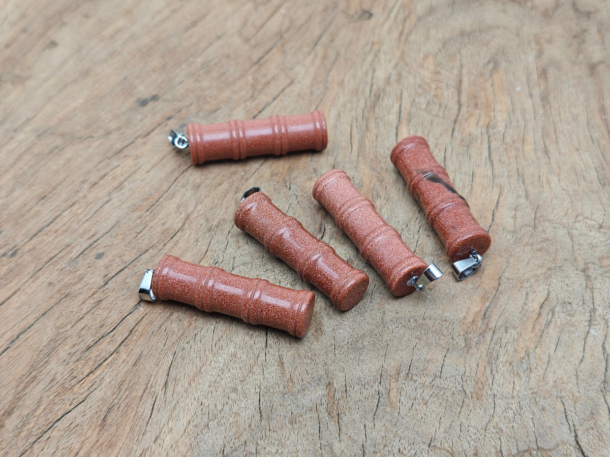 Goldstone bamboo-shaped crystal pendant from GemstoneGO, featuring protective crystal design on a silver chain.