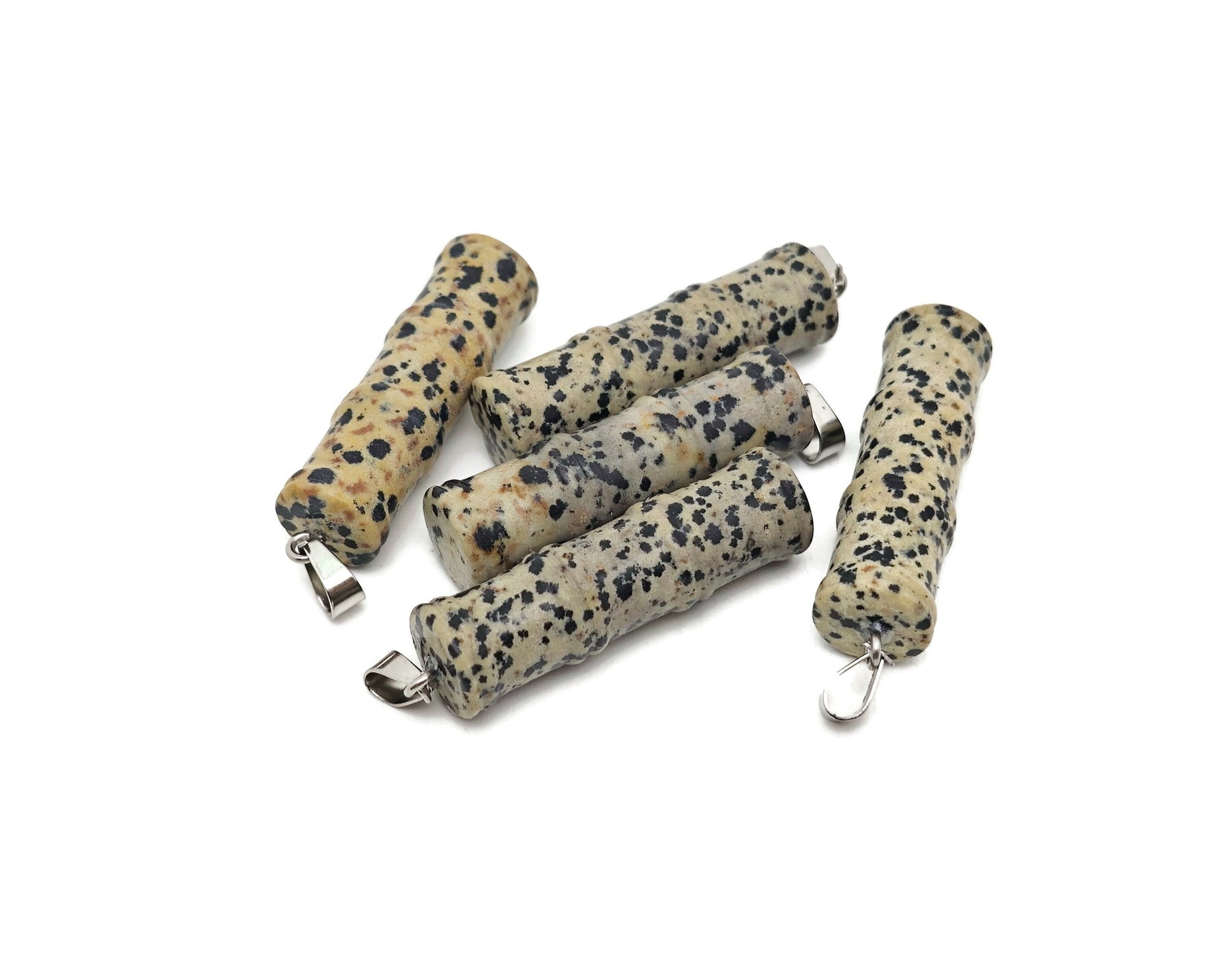 Dalmatian Jasper bamboo-shaped crystal pendant by GemstoneGO featuring a protective crystal design on a silver chain.