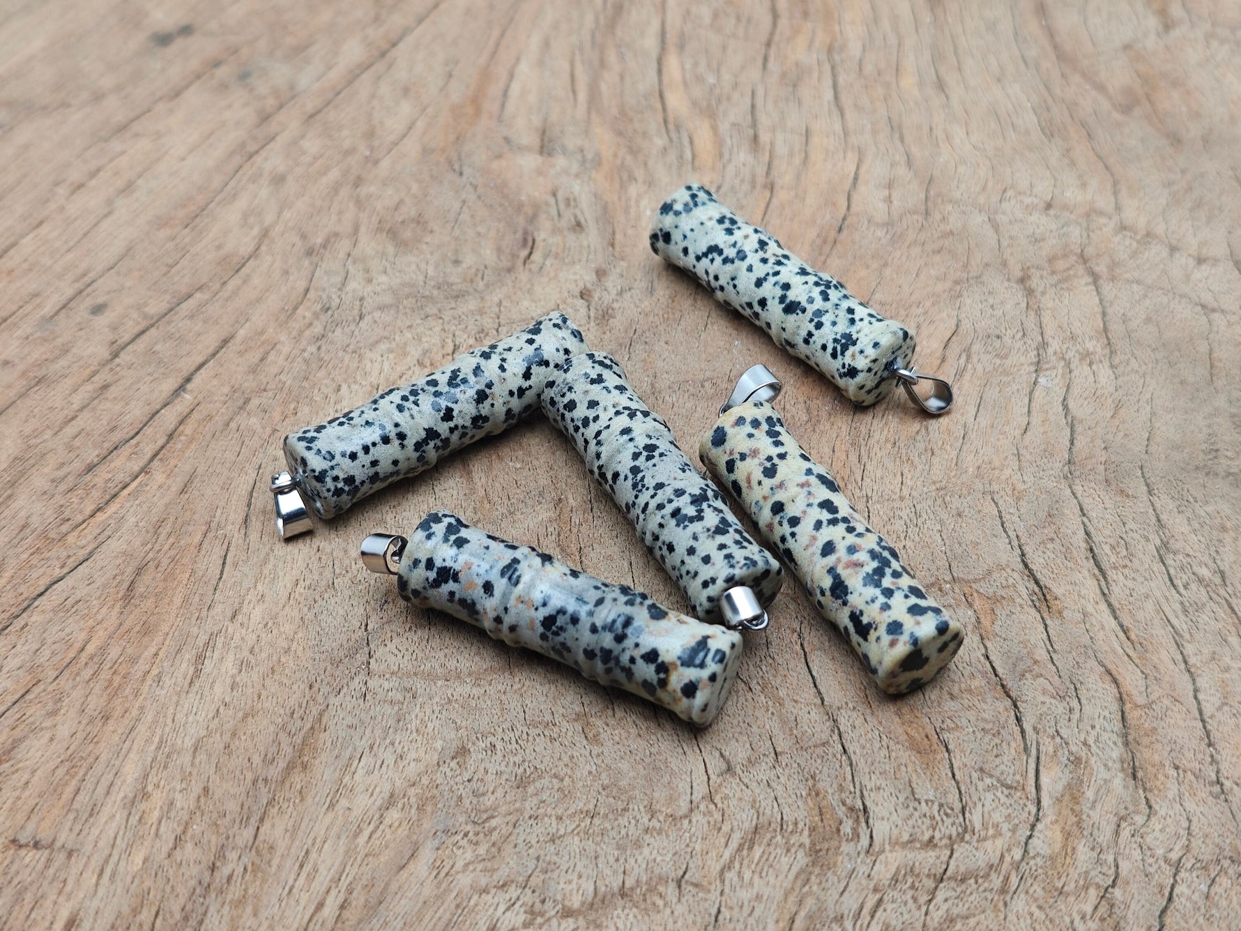 Dalmatian Jasper crystal pendant in bamboo shape, featuring protective gemstone design from GemstoneGO.