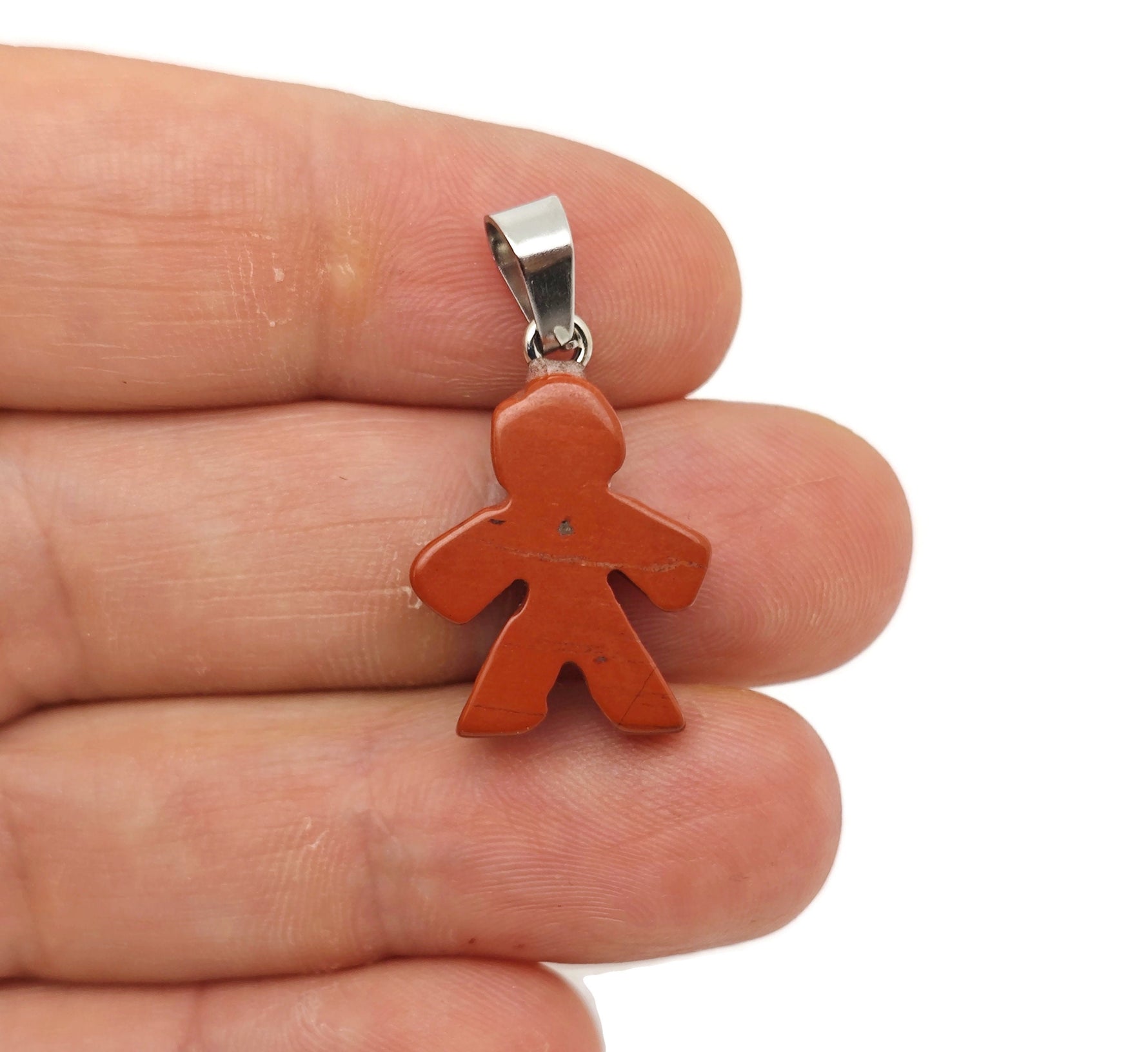 Red Jasper gingerbread cookies men crystal pendant from GemstoneGO, featuring detailed red jasper mineral specimen with gingerbread shape.
