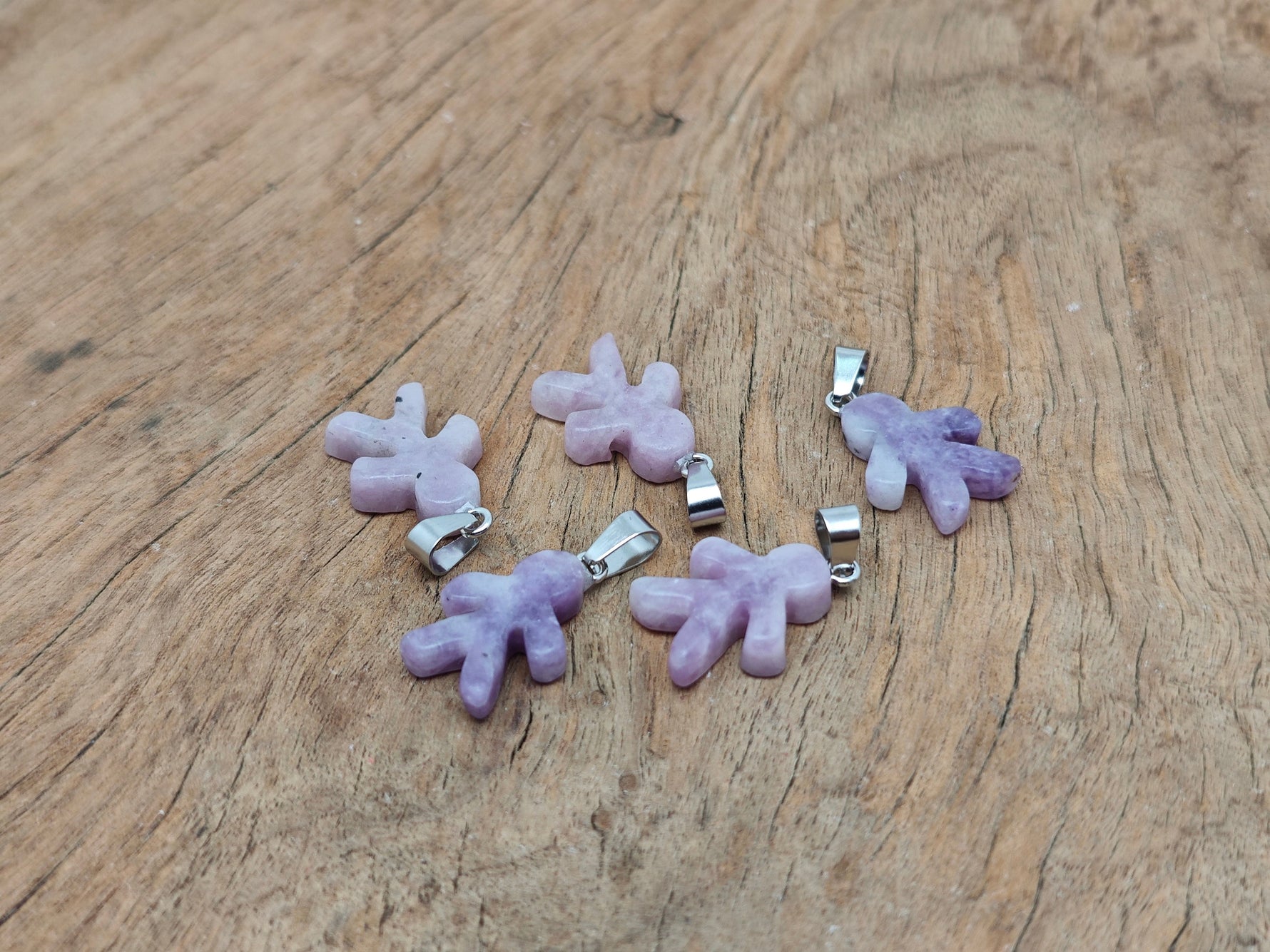 Lepidolite gingerbread men crystal pendant from GemstoneGO featuring mineral specimen design with detailed craftsmanship.