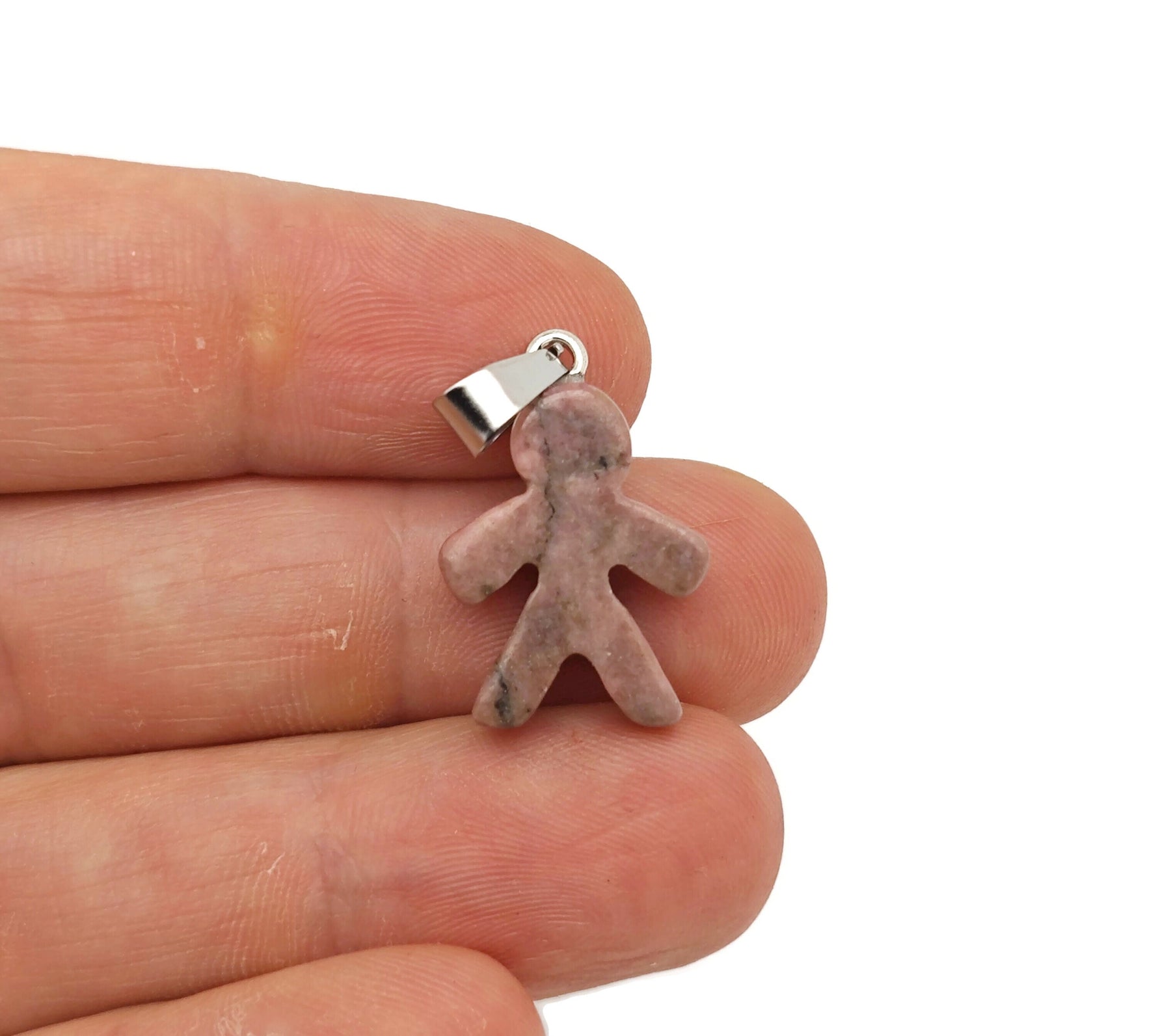 Rhodonite gingerbread man crystal pendant from GemstoneGO featuring polished mineral specimen with detailed gingerbread shape.