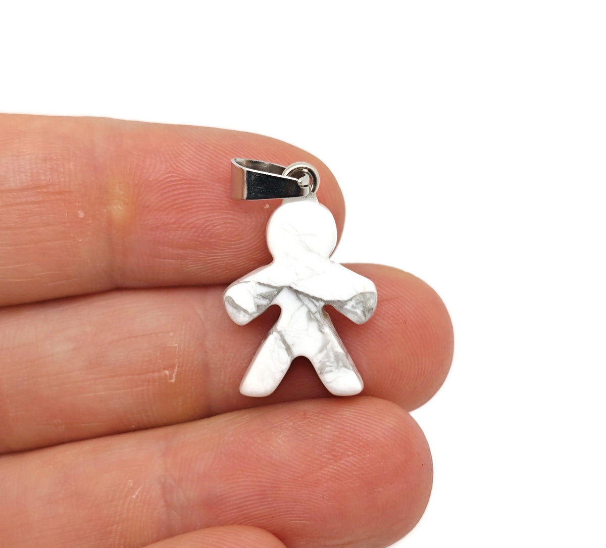 Howlite gingerbread man crystal pendant from GemstoneGO, featuring detailed gingerbread cookie design in mineral specimen style.