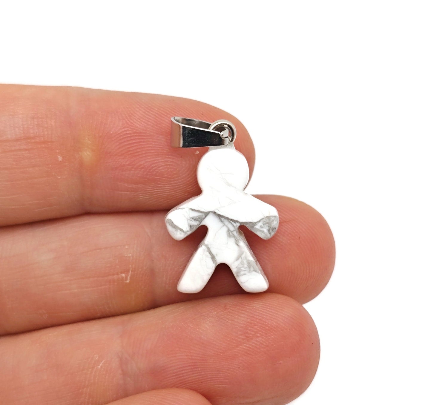Howlite gingerbread man crystal pendant from GemstoneGO, featuring detailed gingerbread cookie design in mineral specimen style.