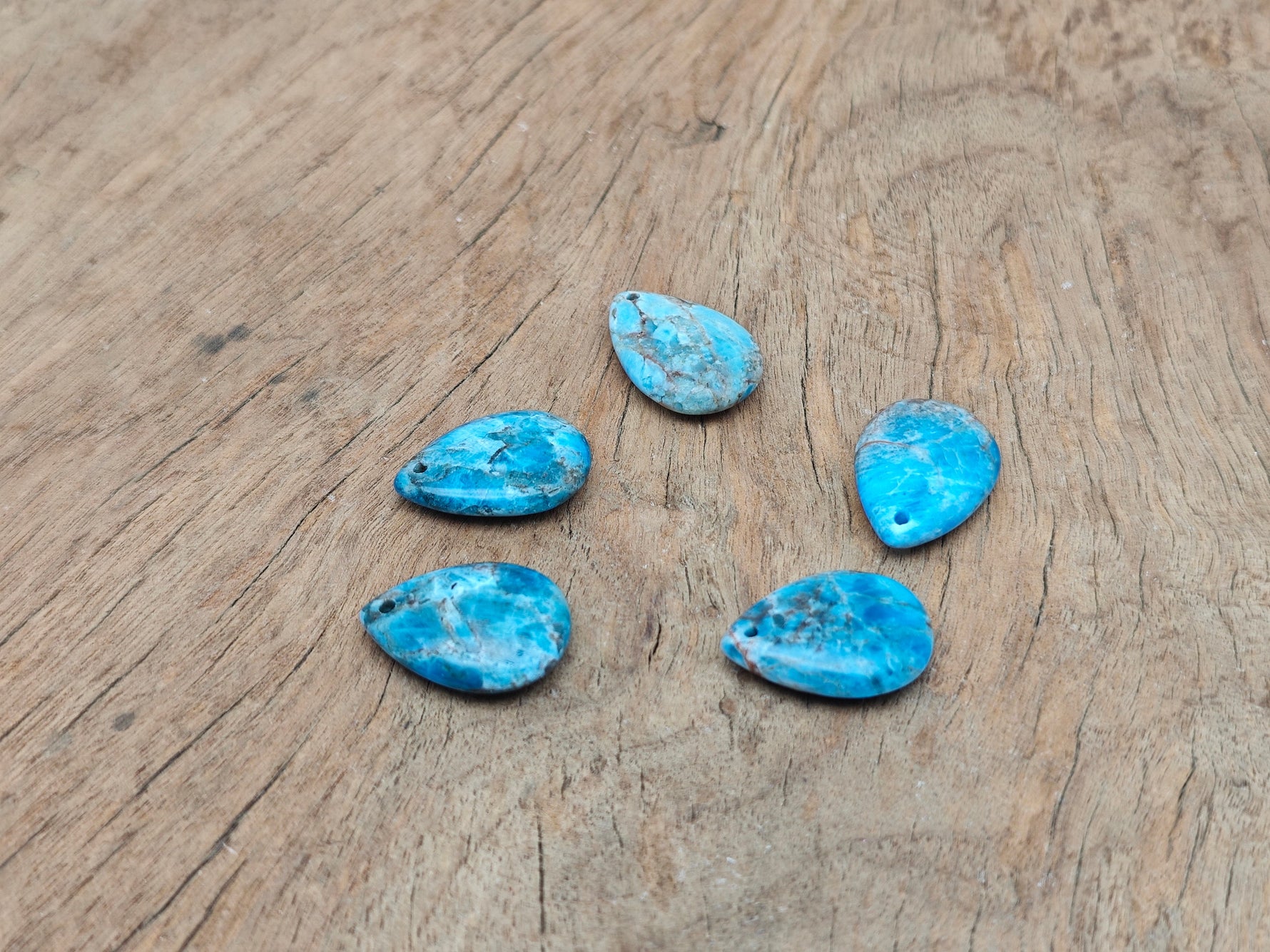Blue apatite dainty drop crystal pendant for DIY jewelry making, featuring a delicate blue gemstone and silver-tone setting.