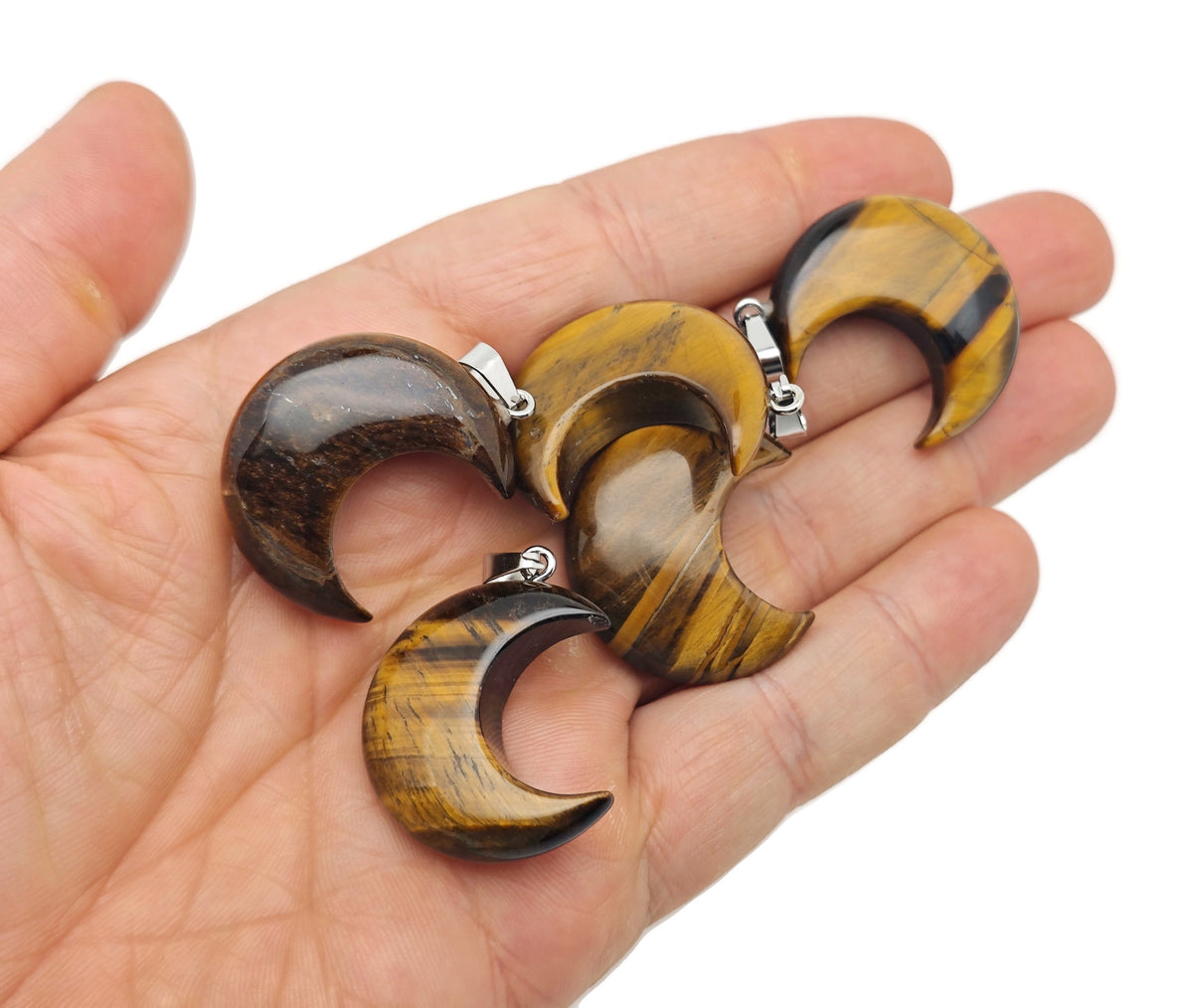 Tiger Eye moon gemstone pendant featuring a crescent moon design by GemstoneGO, showcasing warm, polished tiger eye stone details.