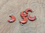 Red Jasper moon pendant featuring a crescent moon design from GemstoneGO, showcasing a polished red jasper gemstone.